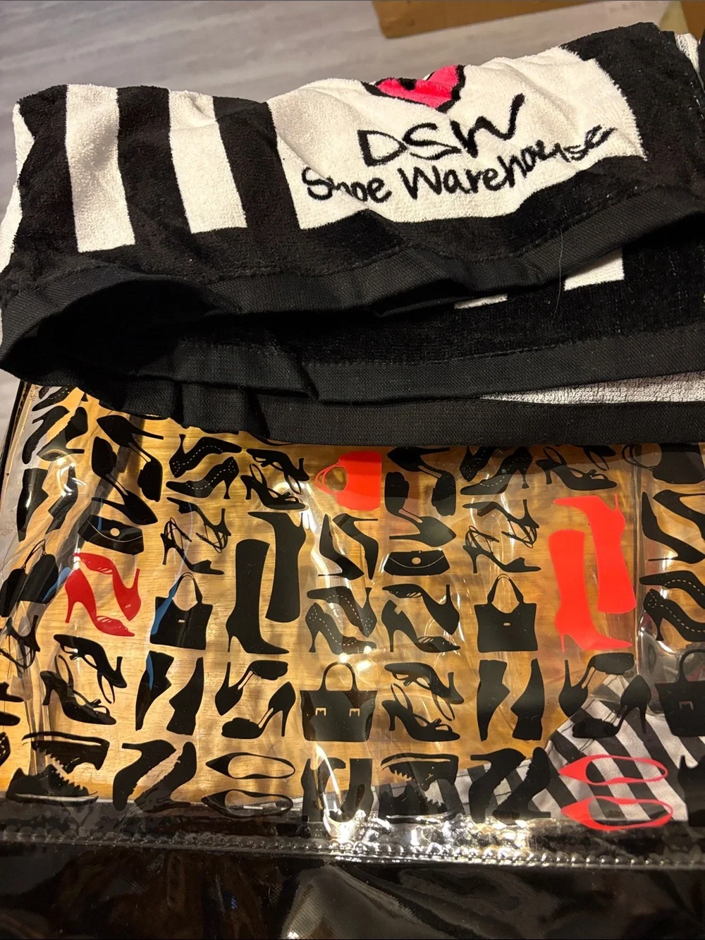 DSW Clear Pouch with Black Shoe Silhouettes and Red Accents with beach towel